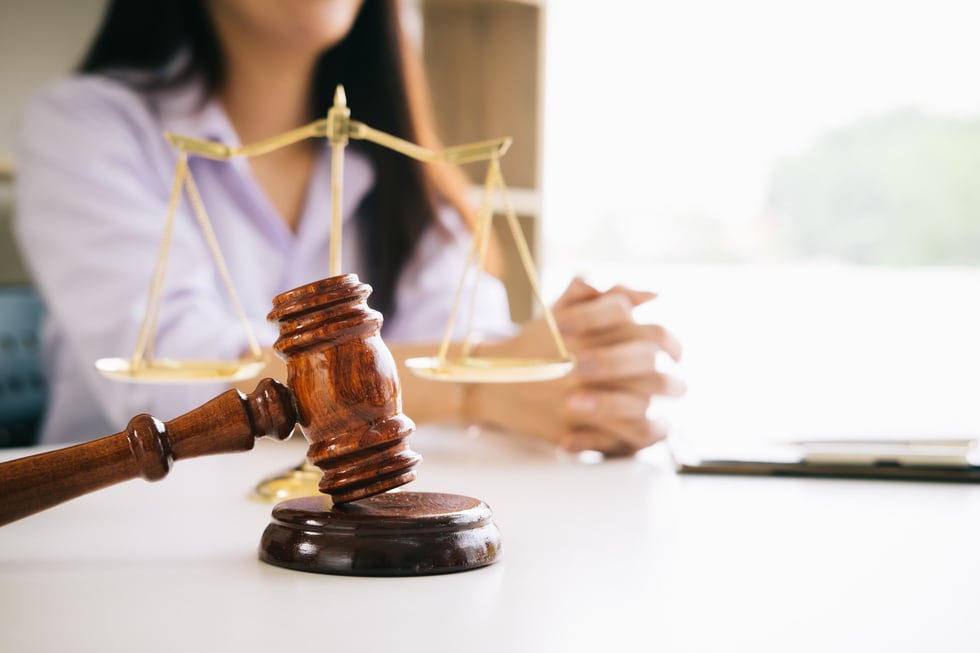 Female Lawyer with Judge Gavel on the Table